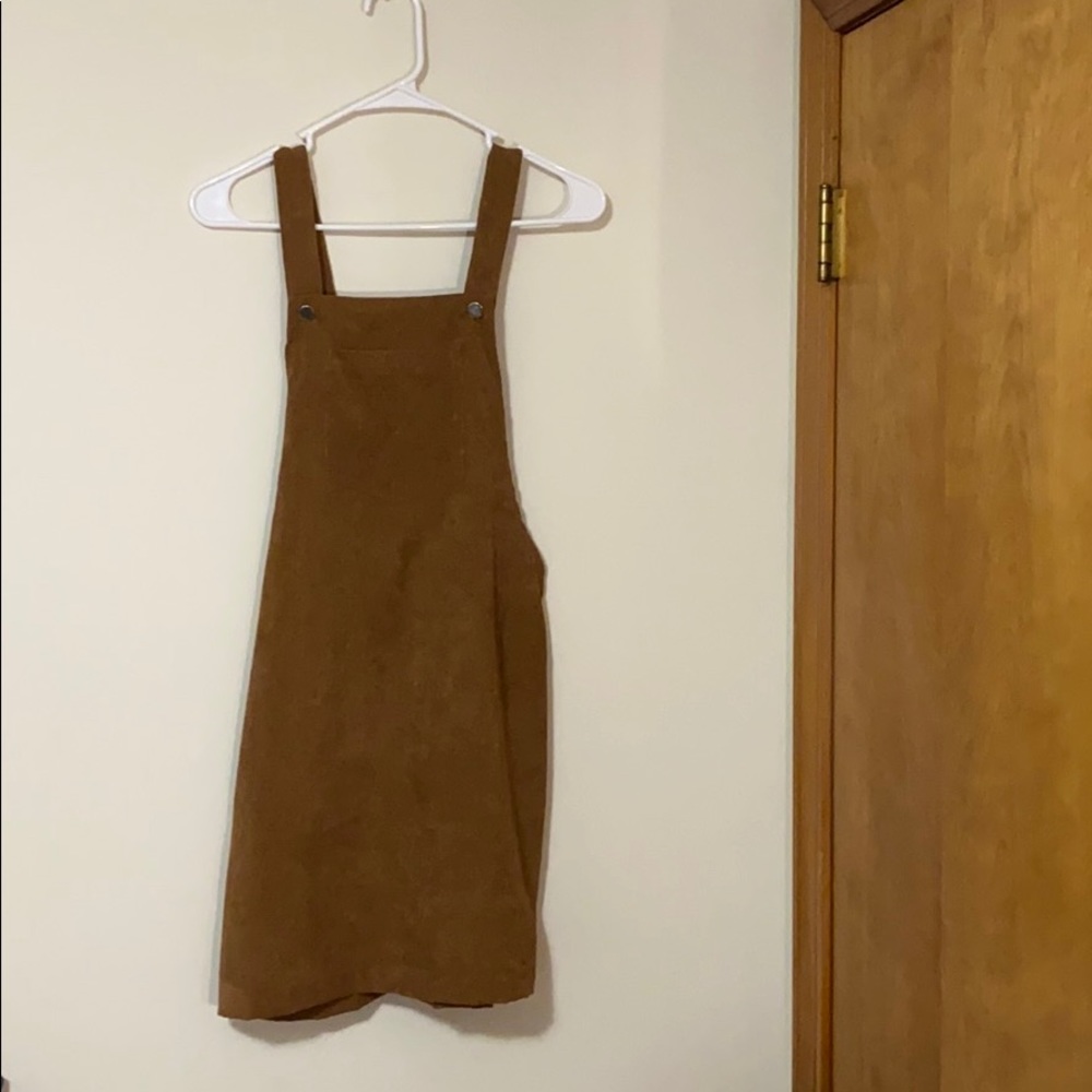 I am selling this dark tan overall dress.
